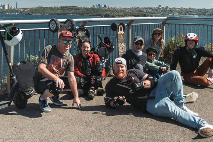 Group of people with e-scooters and e-skateboards