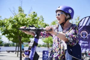 Elderly lady riding e-scooter