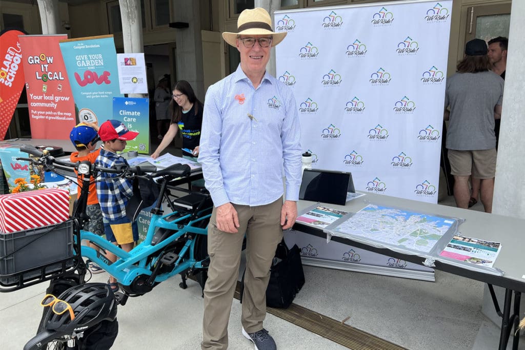 Man in hat standing with ebike at event