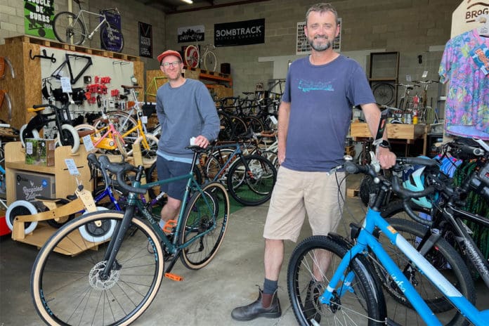Two men standing in a bike store