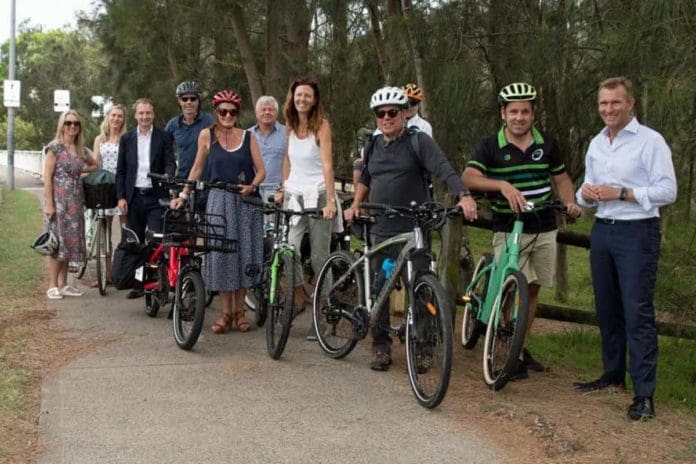 Group of cycling activists standing on footpath with bicycles
