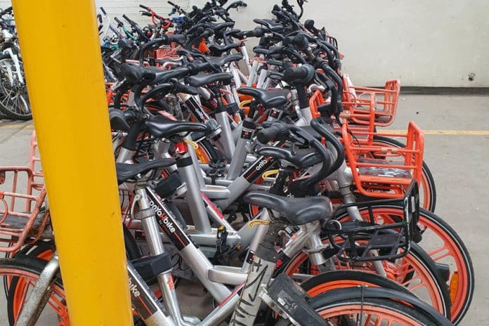 many bicycles lined up in storage