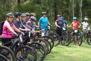 Thirty-two women participating in a Chicks Who Ride Bikes offroad skills workshop in Brisbane