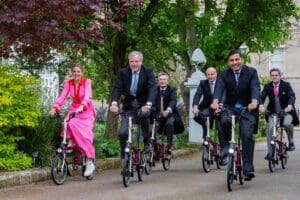 Group of professionals riding bicycles.