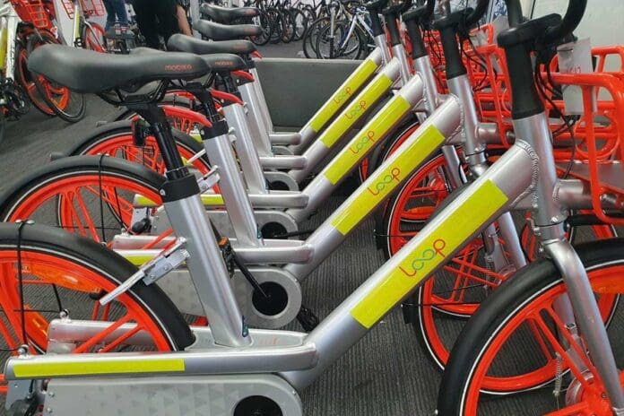 Fleet of e-bikes lined up in storage