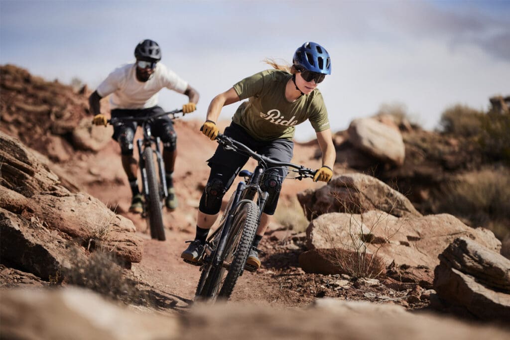 Mountain Bikers riding down dirt track