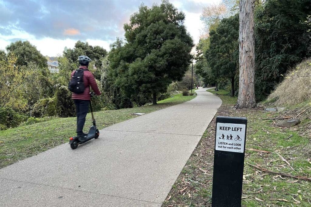 Person riding e-scooter on the Hobart Rivulet path 