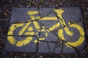 Cracked concrete with bicycle sign