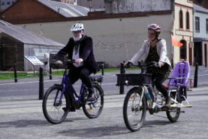 Two people cycling on e-bikes