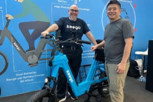 Two men standing with e-cargo delivery bike