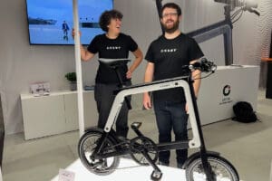 Two people with bike on display at expo