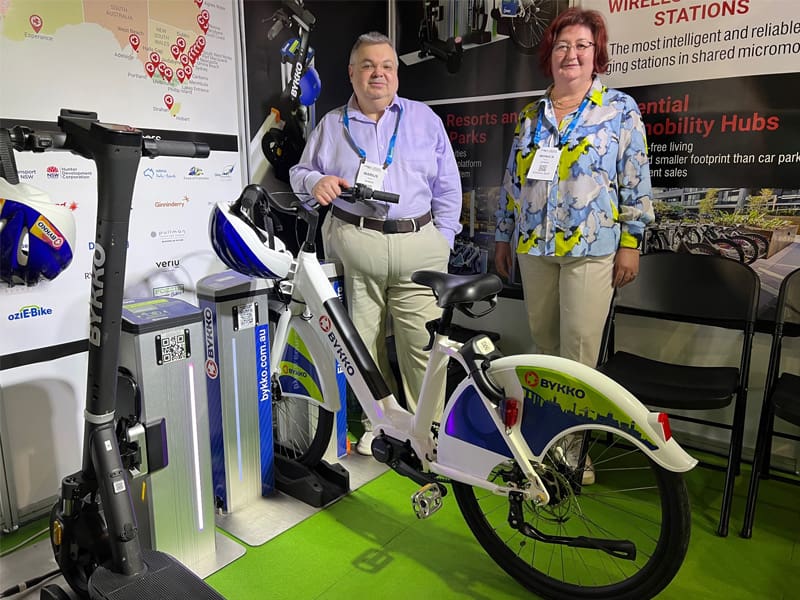 Two people with e-bicycle exhibit