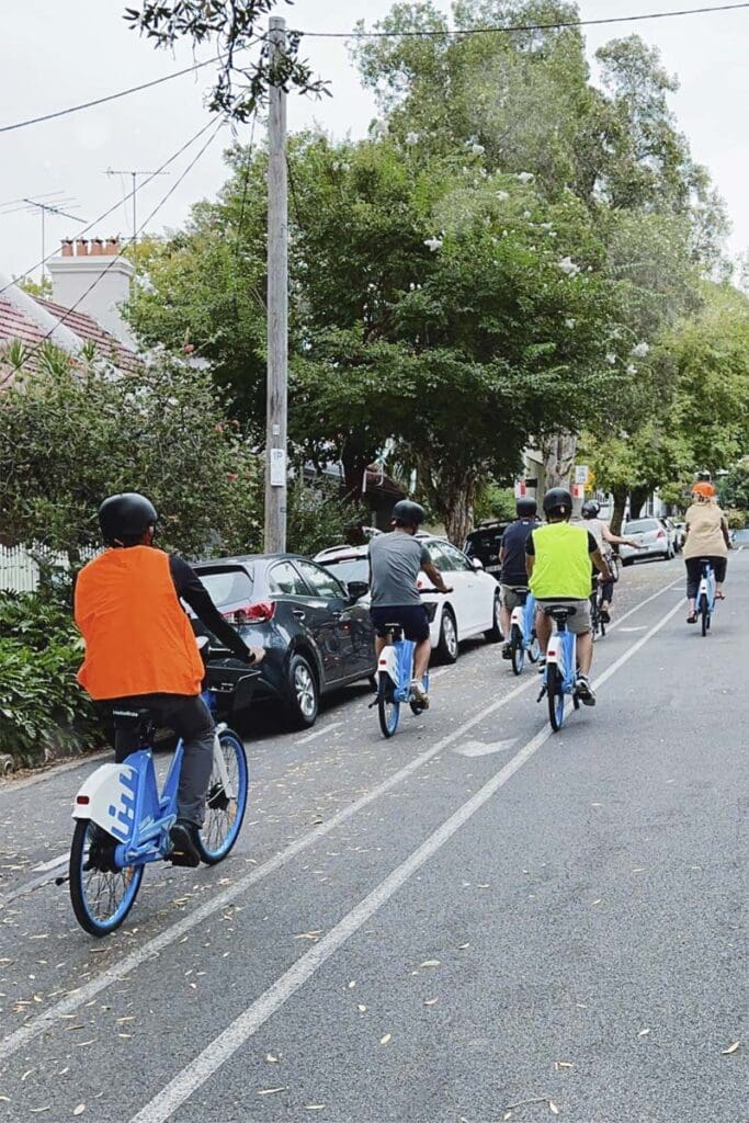 People riding bikes on city street