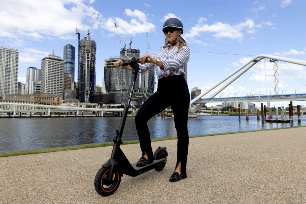 Person with e-scooter in city