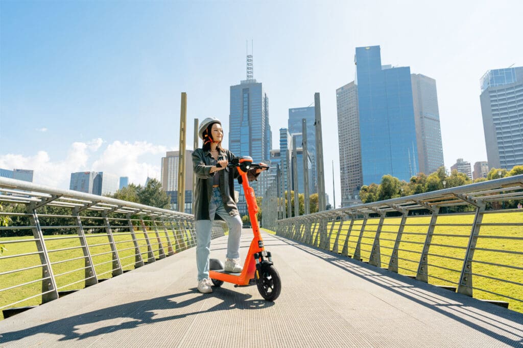 Person with e-scooter in city