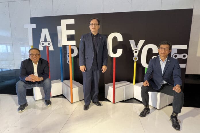 Group of professionals standing in front of Taipei Cycle sign