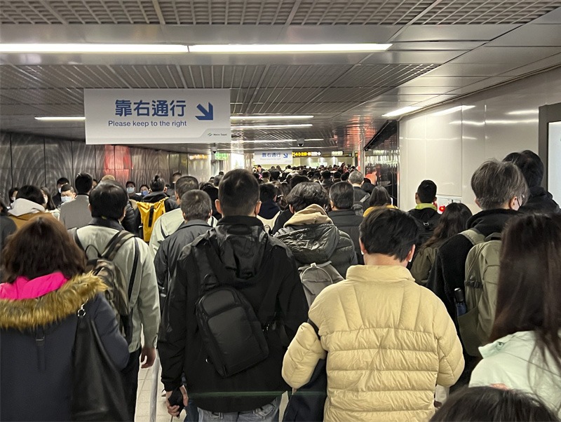 Crowd of people walking through metro station