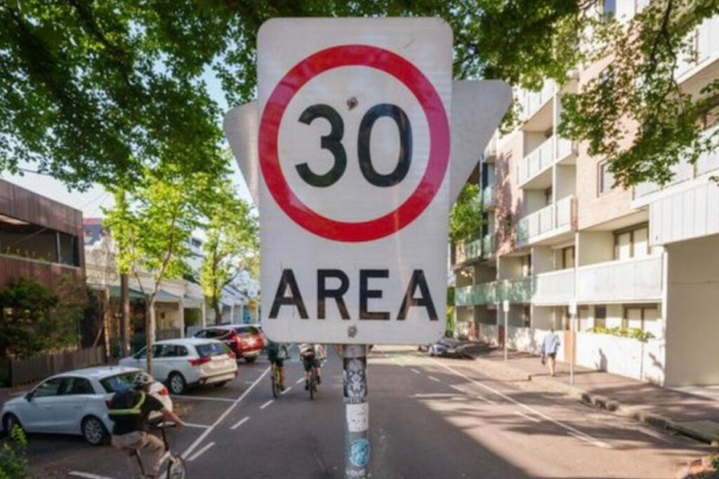 A 30km per hour sign in a city street