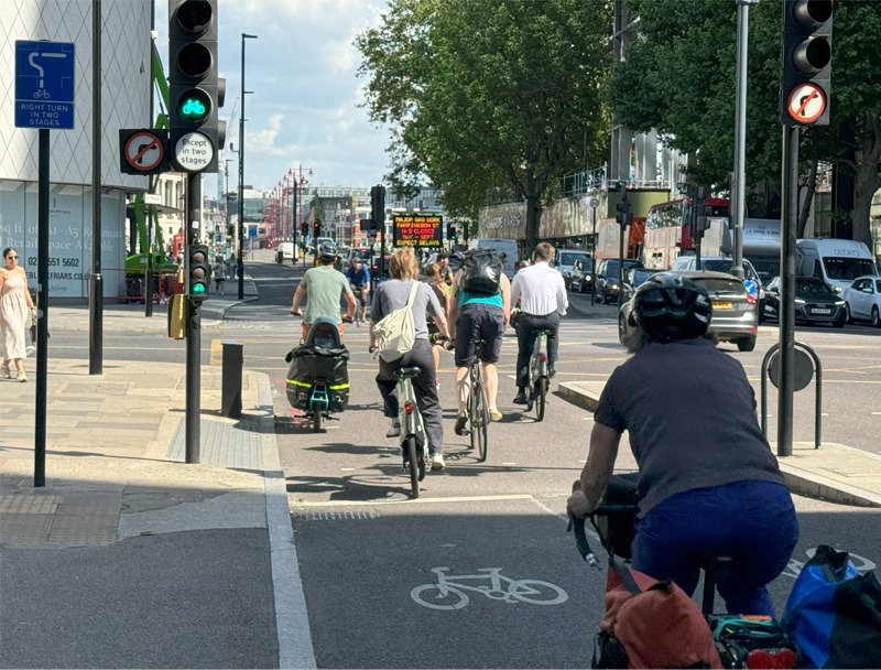 People cycling on a protected cycleway