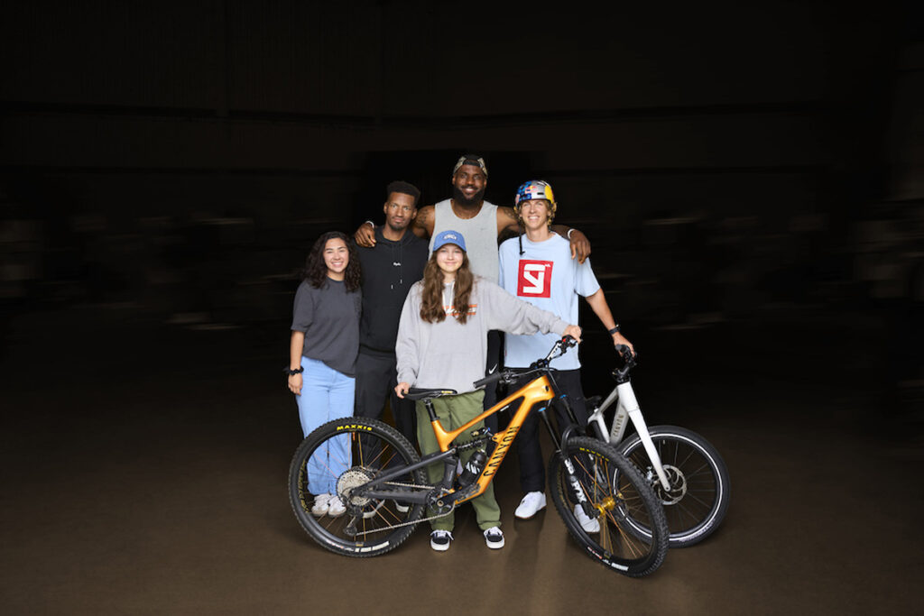 Group of people posing with a bike