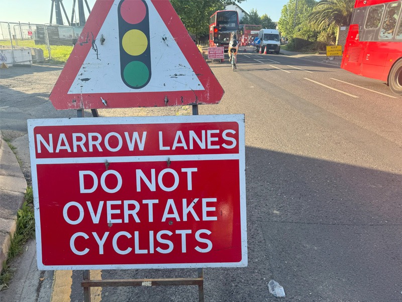 Roadworks sign stating "Narrow lanes, do not overtake cyclists".