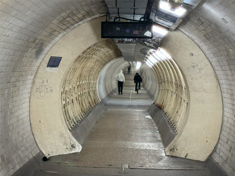 People walking through an underground pedestrian tunnel