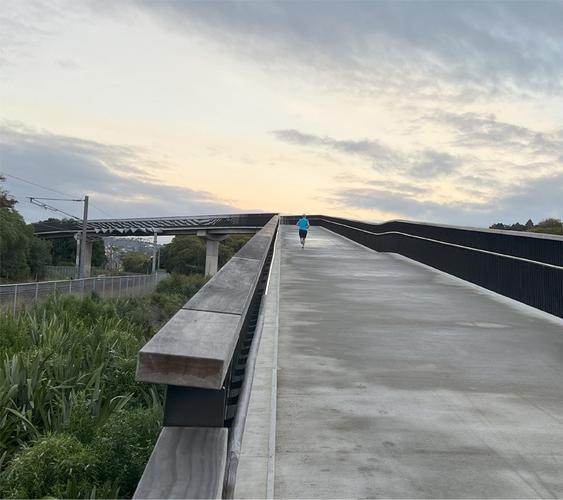 Wide bicycle path going over a bridge.