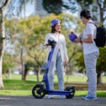 Two people with e-scooter