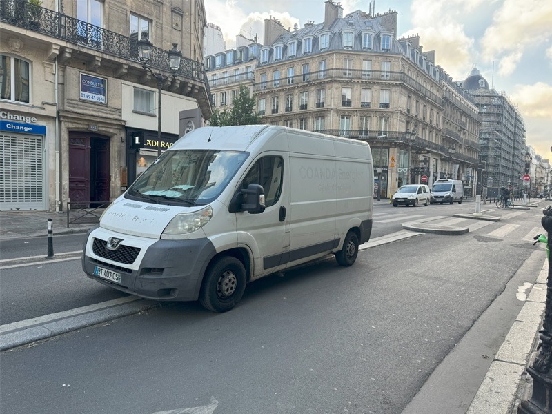 Delivery van parked across a bicycle lane.