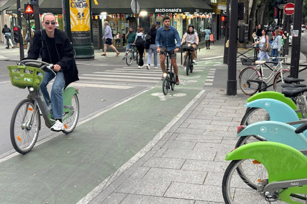 People riding bikes on a Paris street