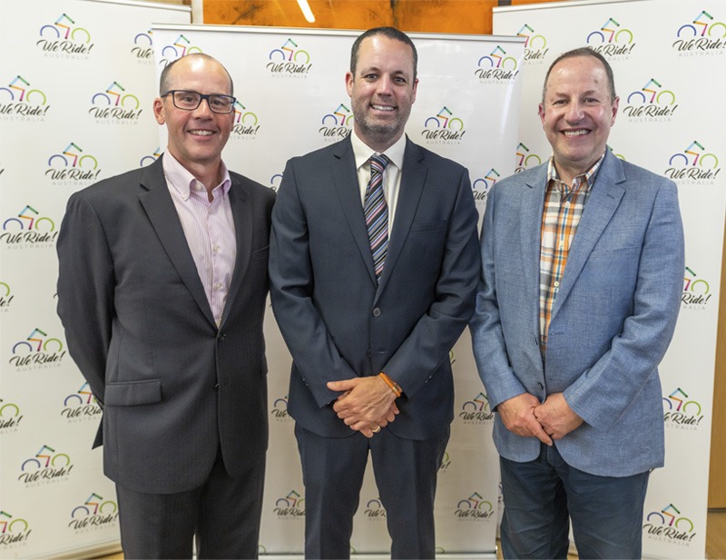 Three men standing for official portrait.