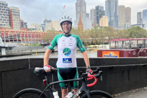 Man standing with bicycle in riding attire