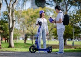 Two people with e-scooter